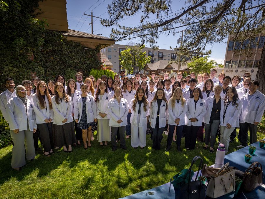 Group picture of medical students wearing white coats at the Anatomical Donation Program memorial service.