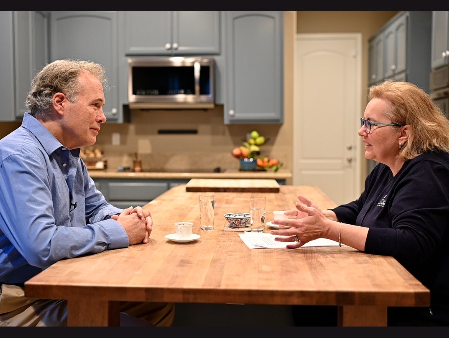 Daryl Lawson with Dean Muge Akpinar-Elci sitting at her kitchen table with Turkish coffee cups in front of them.
