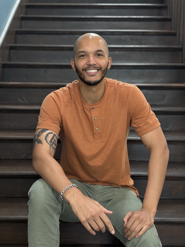 Ford smiling on the stairs in the School of Social Work building.
