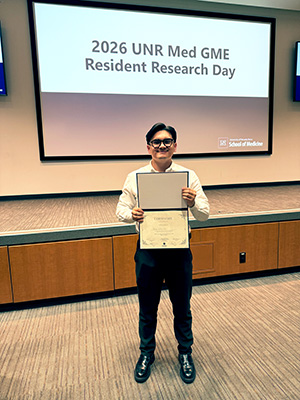 Bryan Vallejo, M.D., holding is first place certificate.