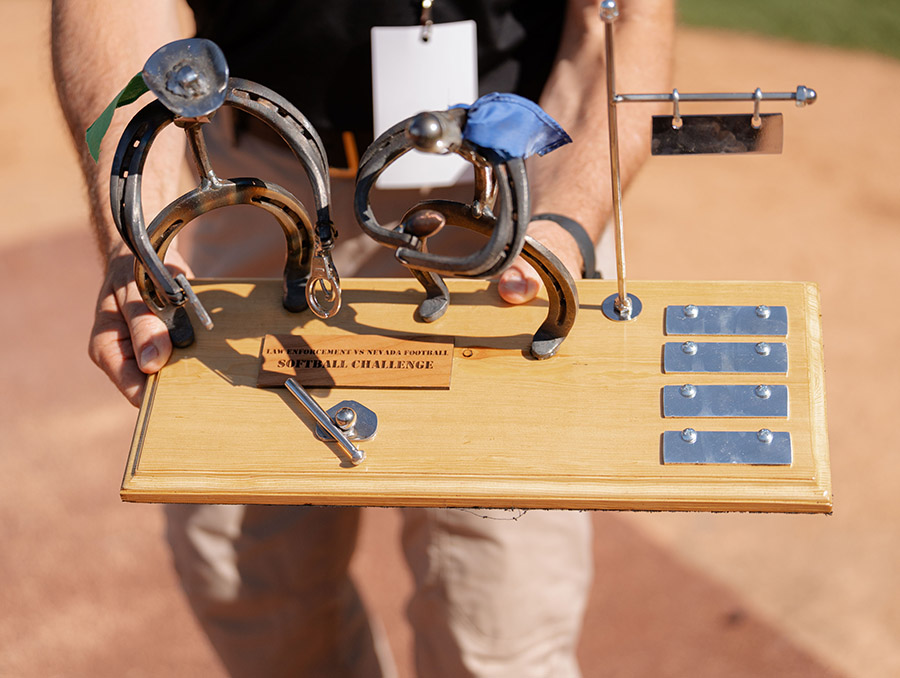 A trophy with two softball figures and four name plates.