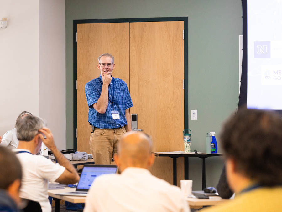Baker Perry stands in front of a classroom leading discussions with workshop participants.