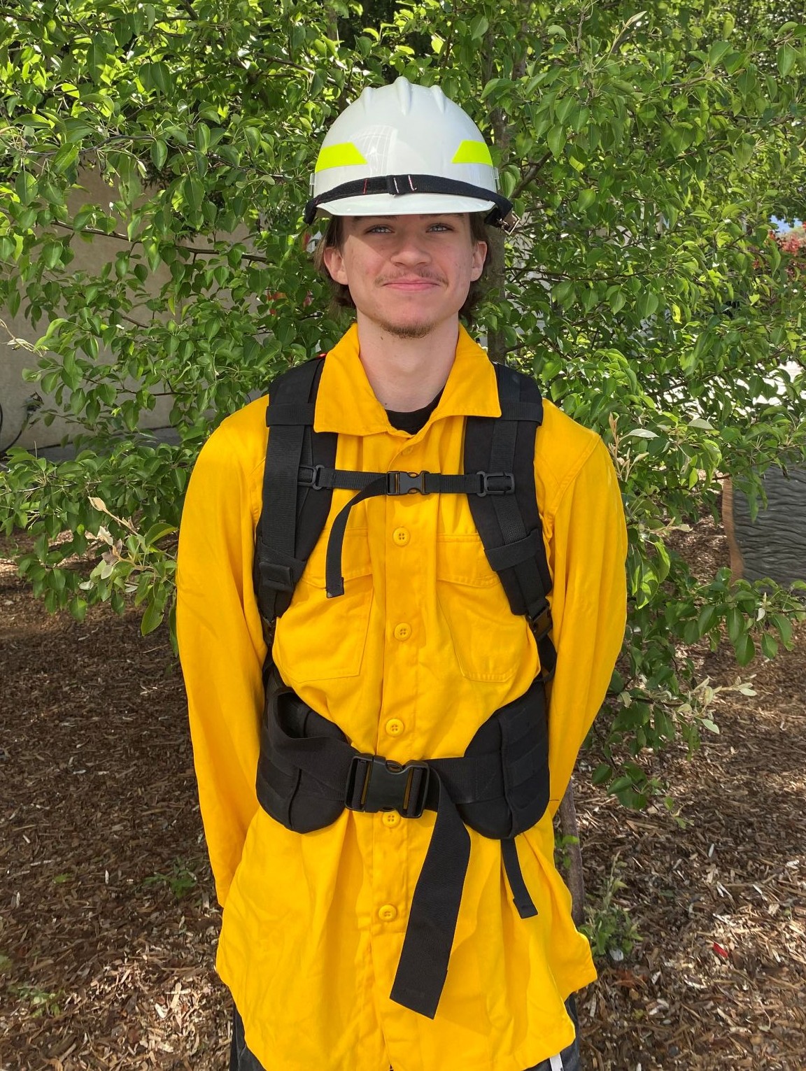 Matthew Hart poses for a photo in firefighting gear. 