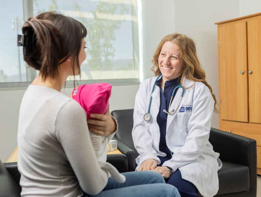 Nurse practitioner student with mother and baby.