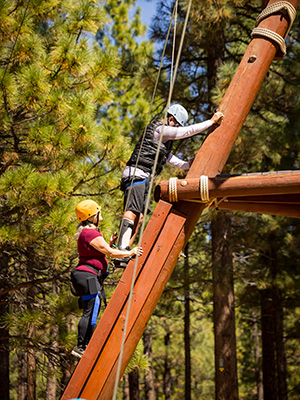 Audrey helping her husband Ricky climb the Alpine Tower wooden course.