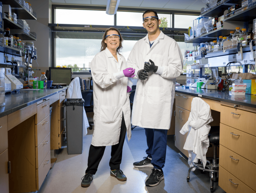 Vanessa Berner, Ph.D. and third-year medical student Peter Asimenios stand in a lab.