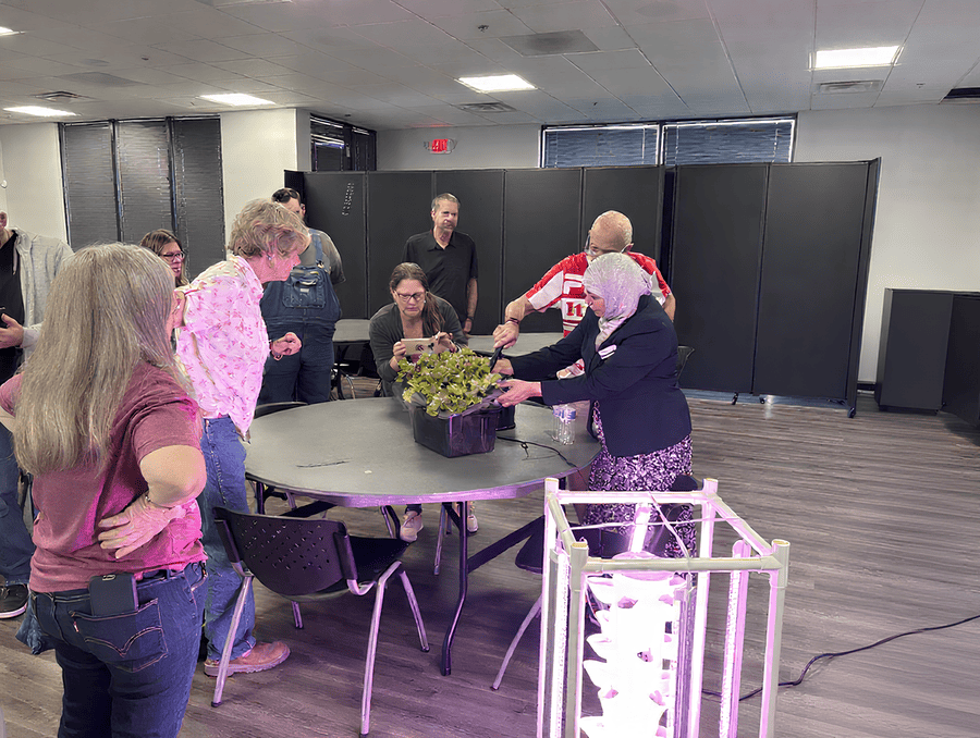 Naznin demonstrating a form of hydroponics to course participants.