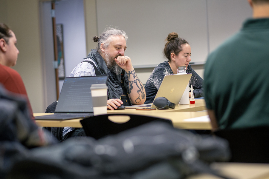 m.e. sits in class workshopping fiction.