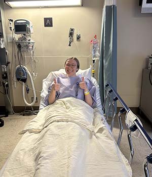 Hannah Schultz on a hospital bed.