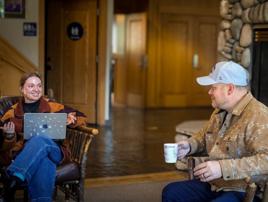 Professor Chris Jeffrey speaks with Morgan Yeager, a graduate student, in a gathering space at the University of Nevada, Reno at Lake Tahoe campus.