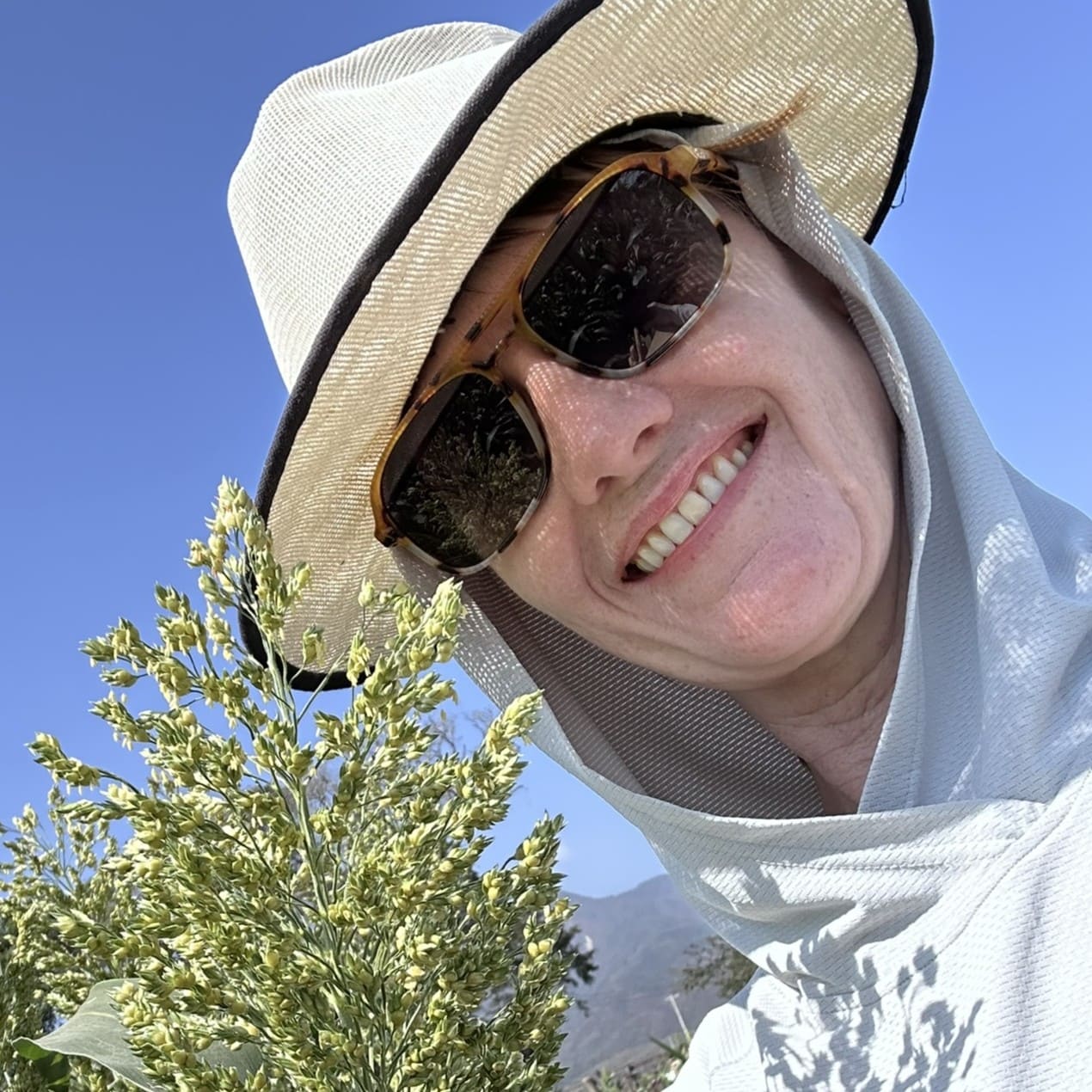 Melinda Yerka posing in a sorghum field.