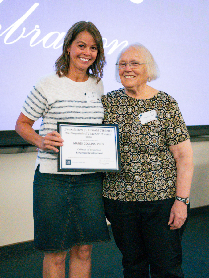 Mandi Collins, Ph.D., stands next to Jannet Vreeland, Ph.D., holding her award.