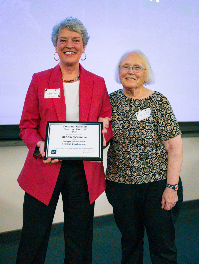 Meggin McIntosh stands next to Jannet Vreeland, Ph.D., holding her award.