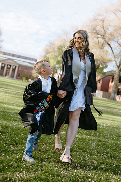 Dana Cooper walks on University Quad with her child.