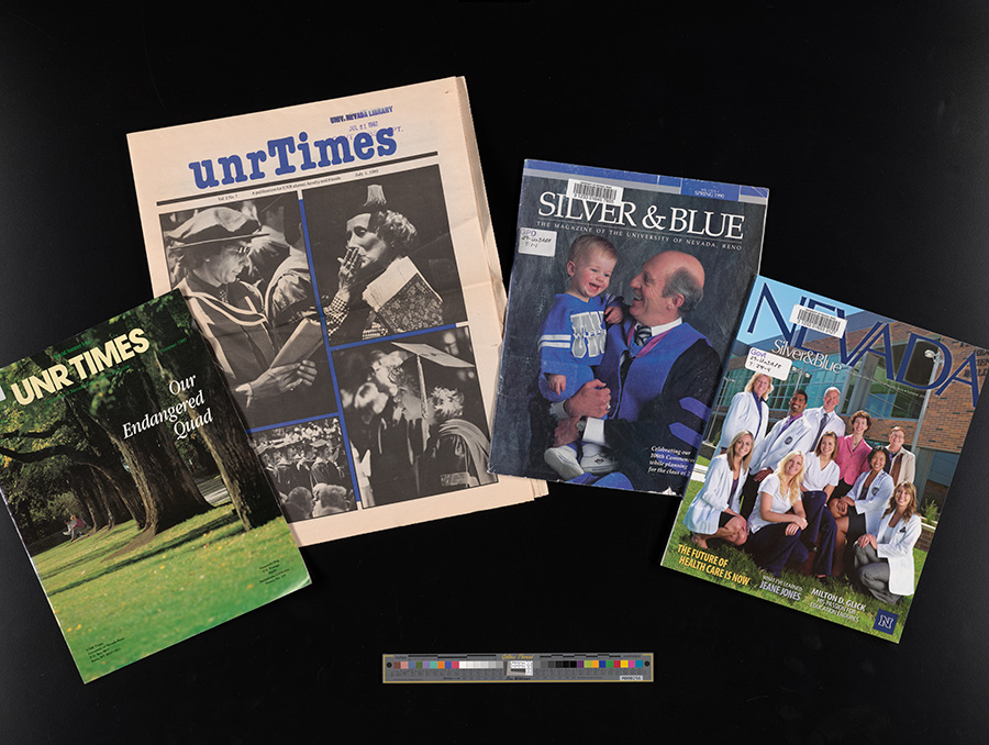 Assortment of university magazines and newspapers laid out on a dark background, including UNRTimes, Silver & Blue, and Nevada, showing different cover designs with people, campus scenes, and publication titles visible.