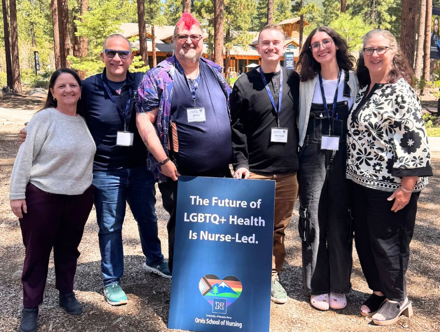 Summit participants from the University outside at the Tahoe campus in front of a LGBRTQ+ Nursing Summit sign.