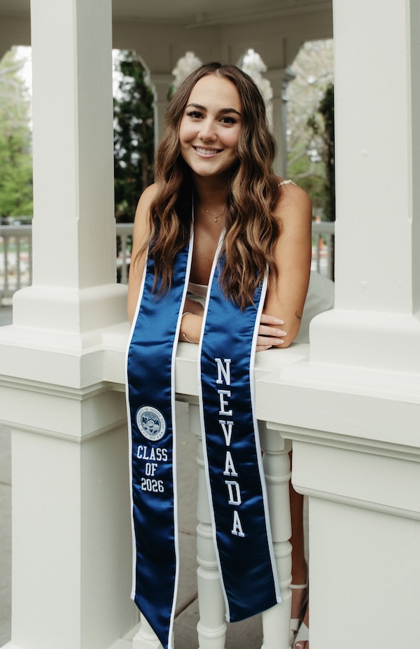 Emma Lawson in a commencement sash on campus.