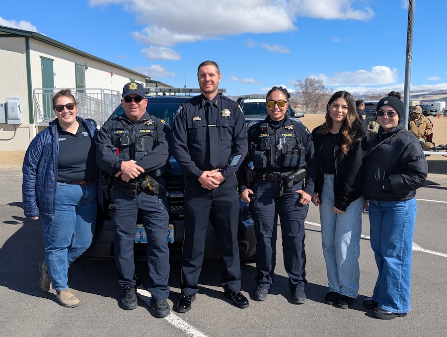 Officers and staff of the University Police Department-Northern Command pose together outside.