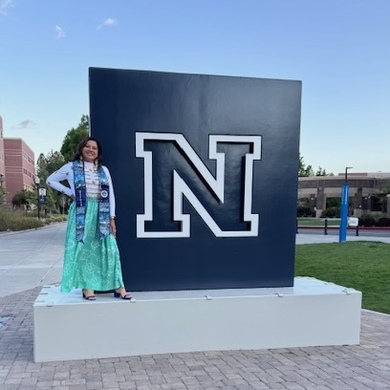 Misty Youngbear at the Nevada block N monument on campus.