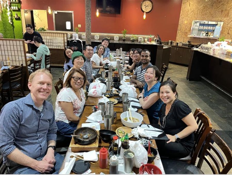 Faculty and staff seated around a large table at Ijji Noodle House & Poke Don.