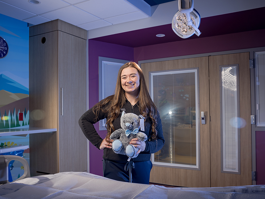 Bailey Ivory holds a stuffed animal in a hospital room at Renown Children's Hospital.