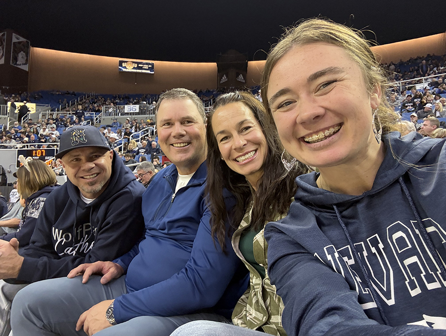 Bailey Ivory with her family members at a Wolf Pack basketball game.