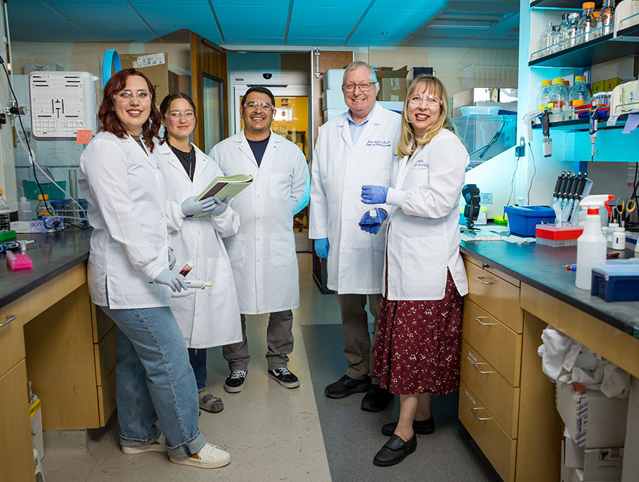 Members of the Burkin Lab dressed in PPE in the laboratory.