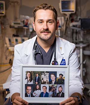 Cameron Shonnard holding a picture of his family. 