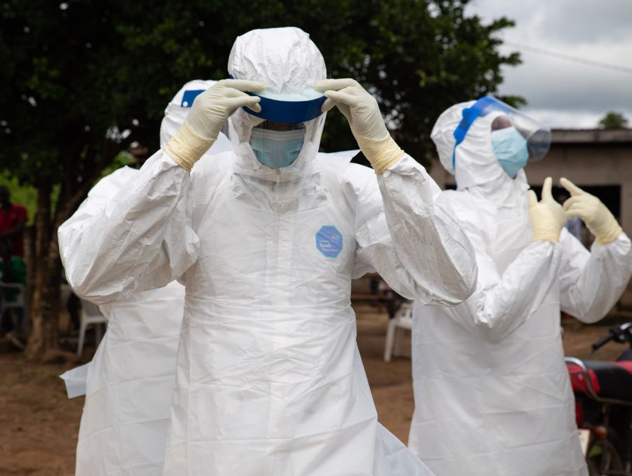 Medical workers in protective clothing to prevent disease.