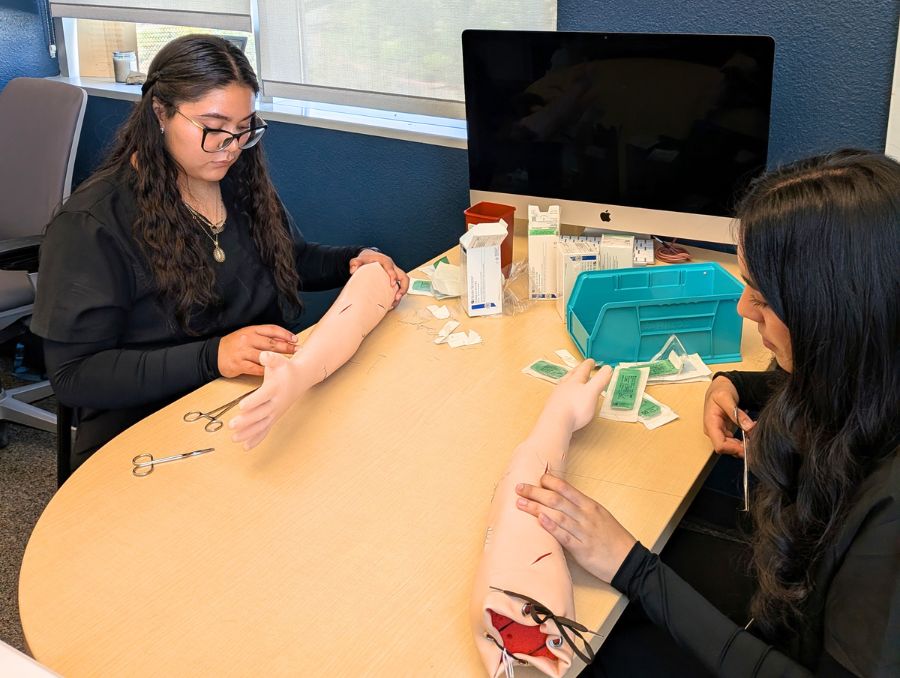 Fatima and Jaqueline practicing suturing