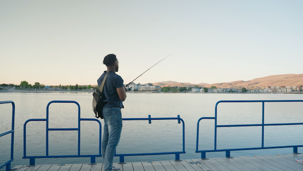 Luka at the Sparks Marina, casting a fishing pole into the water.