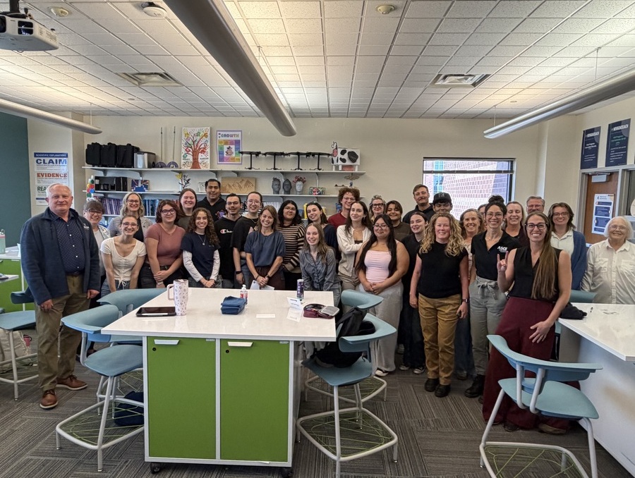 A classroom full of students with Mandi Collins along with Provost Thompson.