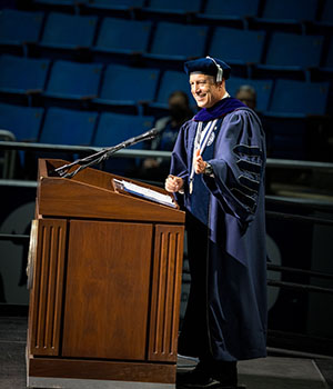 President Brian Sandoval speaking at the podium at the 2026 M.D. Commencement Ceremony.