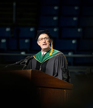 John Spertus addresses the crowd at the 2026 M.D. Commencement Ceremony.
