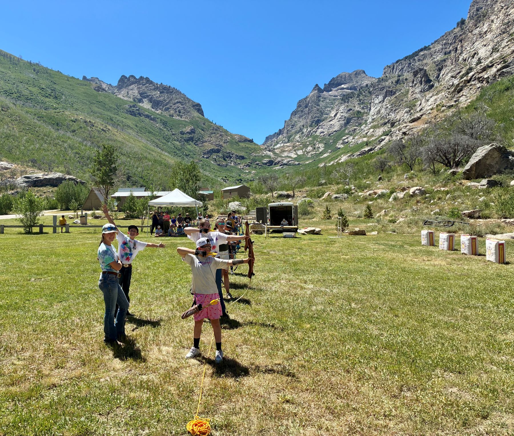 A group of students aiming at archery boards.