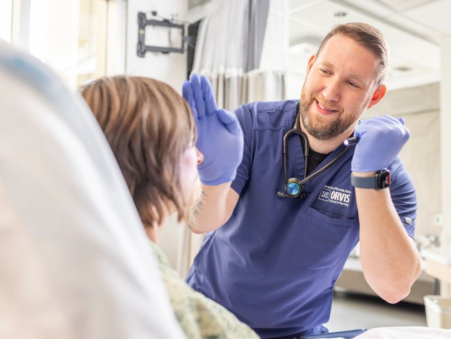 Nursing student examining a patient.