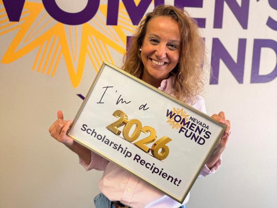 Gokce, smiling, and holding a certificate from the Nevada Women&rsquo;s Fund that says &ldquo;I&rsquo;m a 2026 Scholarship Recipient!&rdquo;