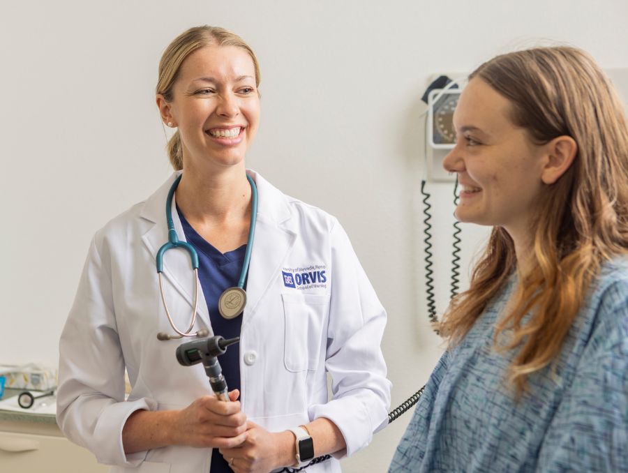 Nurse practitioner student with a patient.
