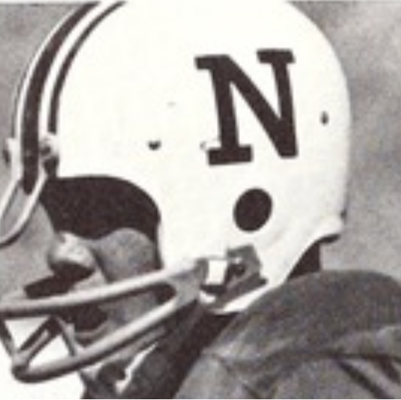 A black and white image from 1967 of a Nevada football player with a N logo on the side of his helmet.