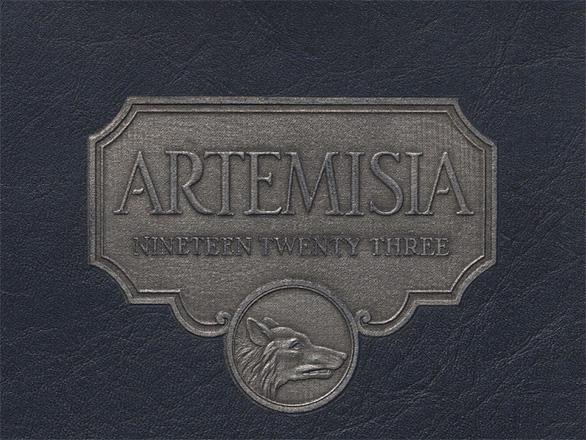A navy blue cover of the yearbook that reads "Artemisia Nineteen Twenty Three" featuring a Wolf head medallion in silver.