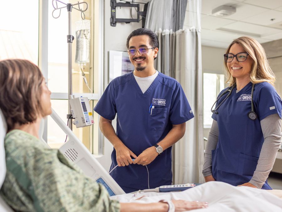 Two nursing students with a patient