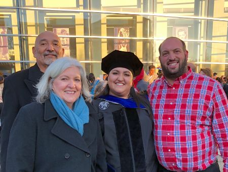 Luisa Lucero celebrates earning her doctorate with family members.