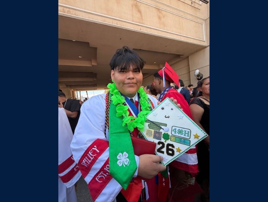 Luis Arguello showing off his 4-H badges.