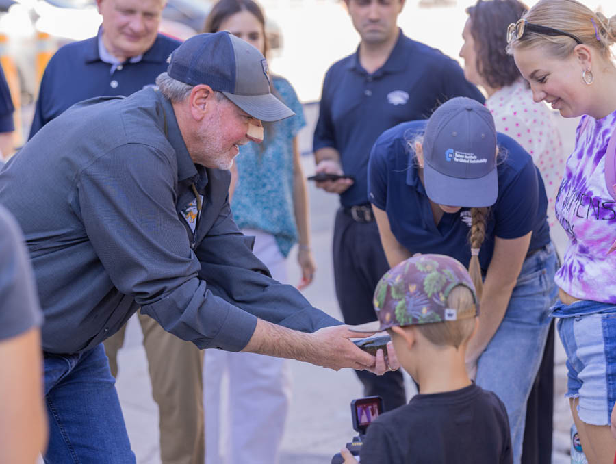 Chris Crookshanks of the Nevada Department of Wildlife shows participants a fish.