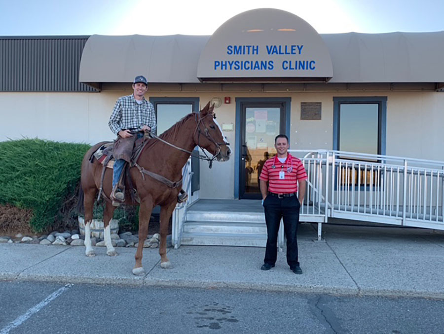 Kaleb Wartgow, M.D., on horseback in front of the Smith Valley Physicians Clinic.