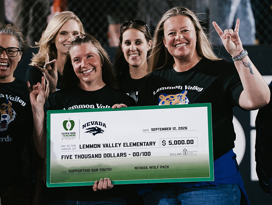 Three women hold and oversized check made out to Lemmon Valley Elementary School for $5,000