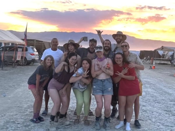 The Dusty Dillas camp celebrates at Burning Man sunset.