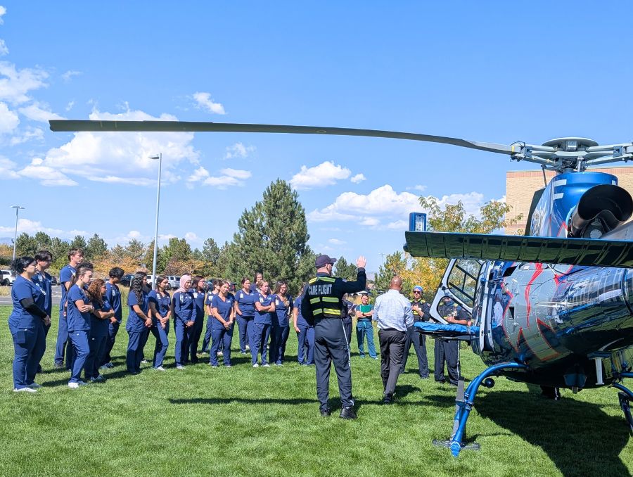 A group of students and REMSA Care Flight staff near helicopter