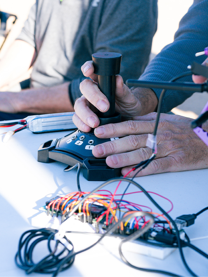 A hand resting on a joystick.