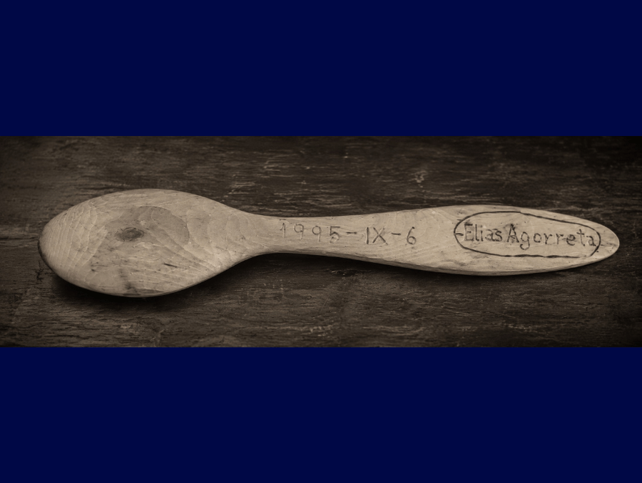 A wooden spoon with "Elias Agorreta" engraved on the handle.